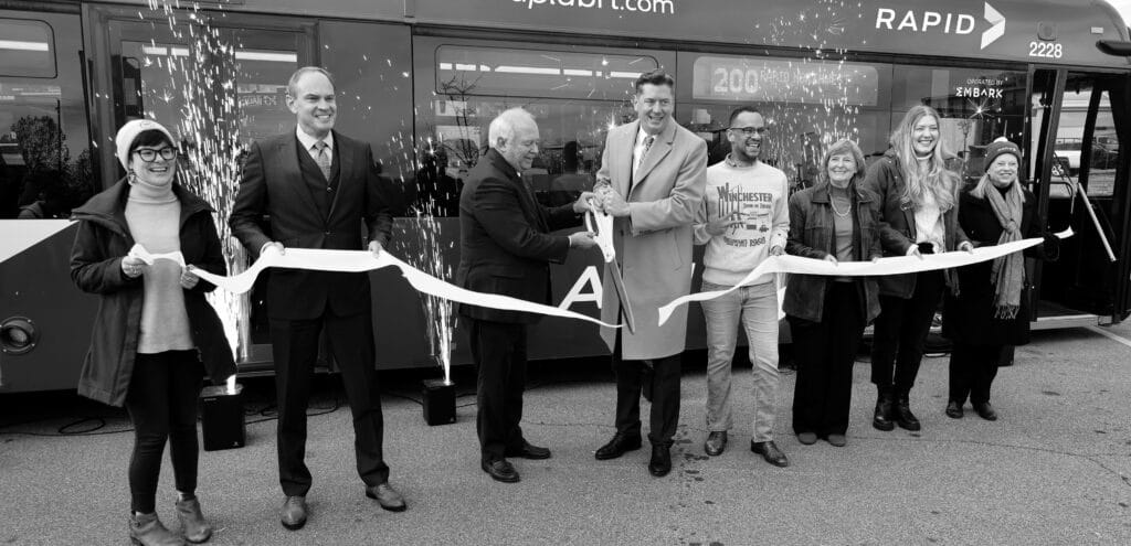 The official ribbon cutting at the EMBARK RAPID bus line launch event.