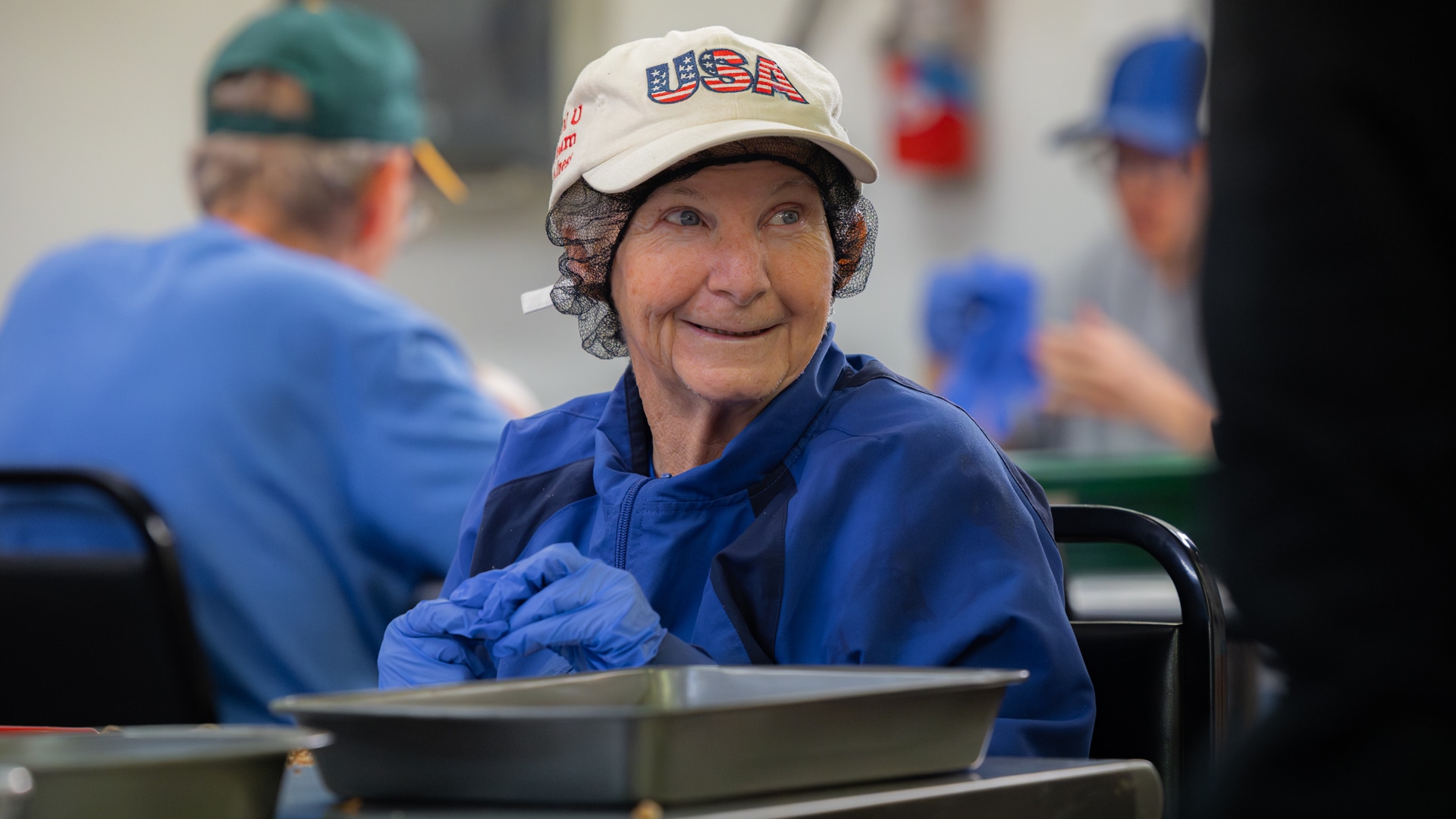A CARC resident shelling pecans by hand.