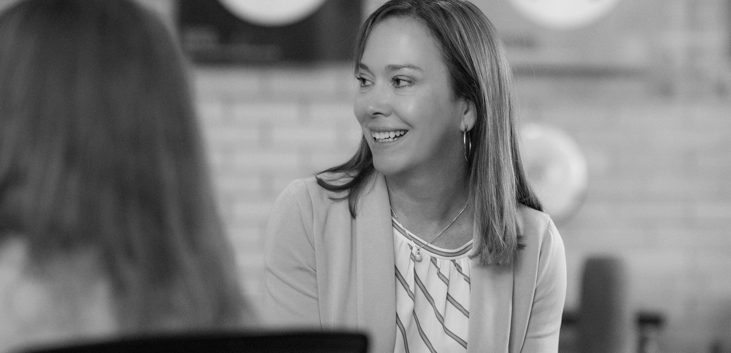 A Koch Comm executive vice president smiling and engaging at a staff retreat.