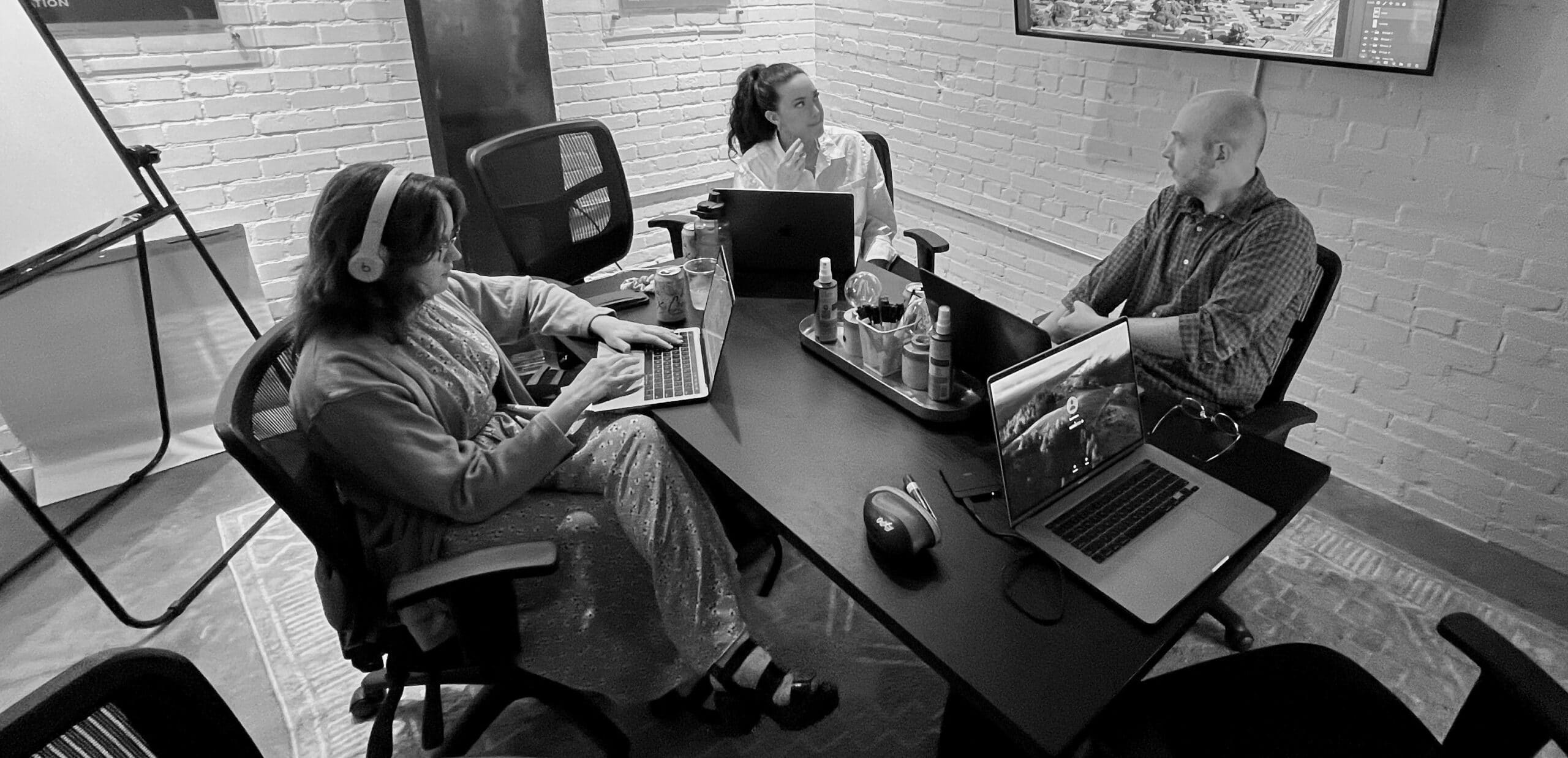 The Koch Comm creative team strategizing for a client's website design.
