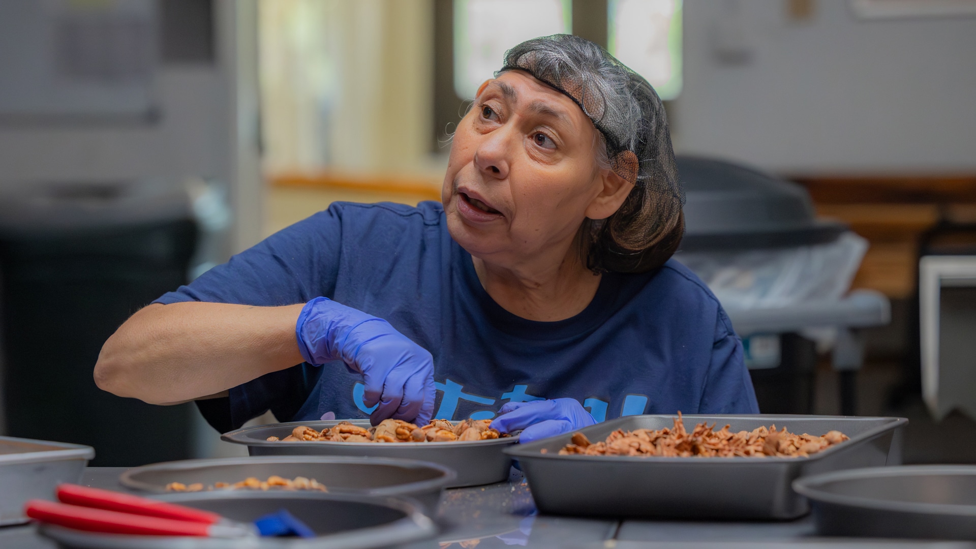 A CARC resident shelling pecans by hand.