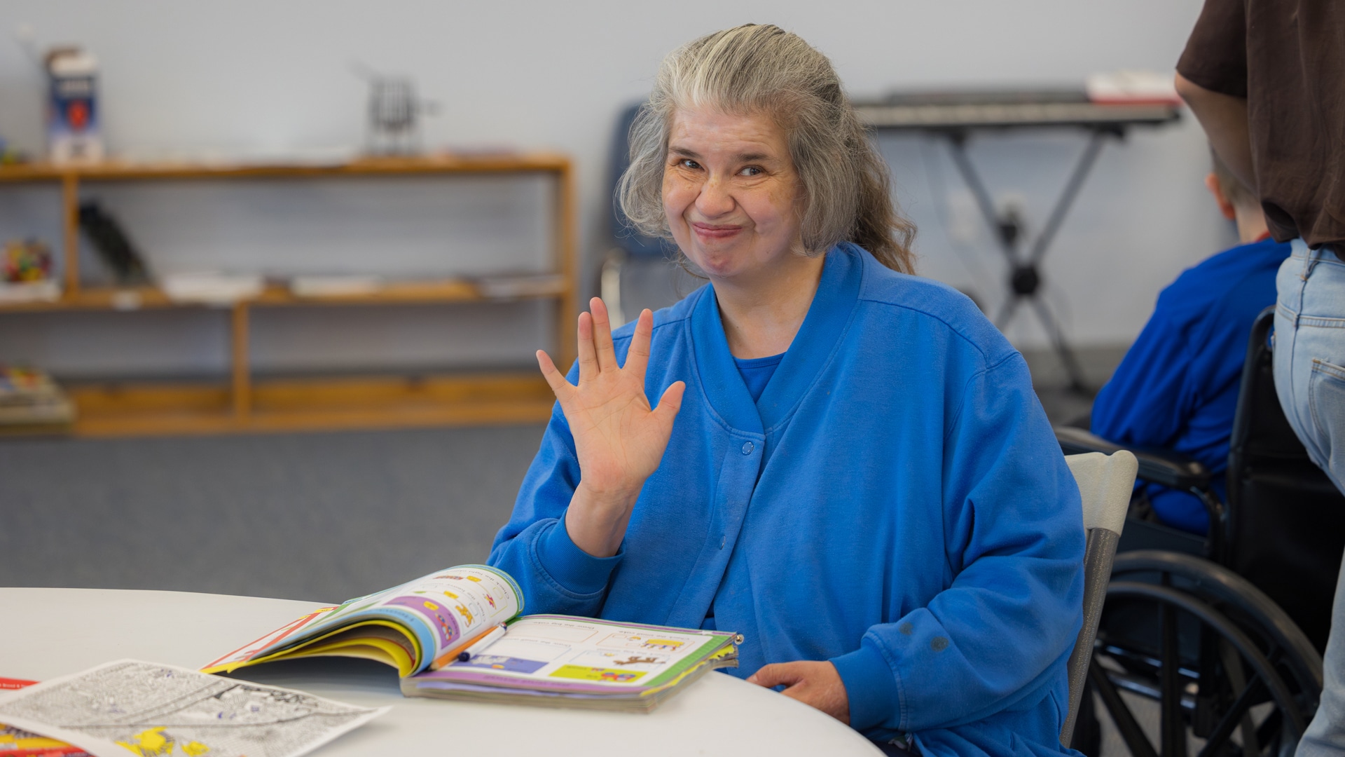 A CARC resident waving at the camera at a campus event.