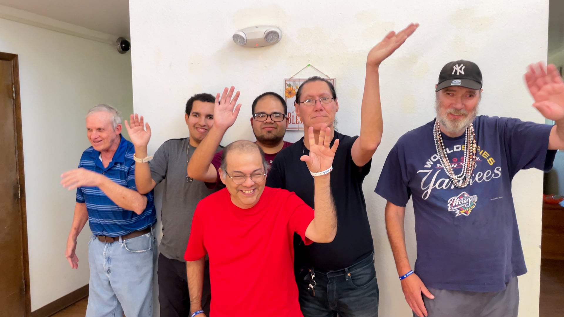 CARC residents waving joyfully at the camera.