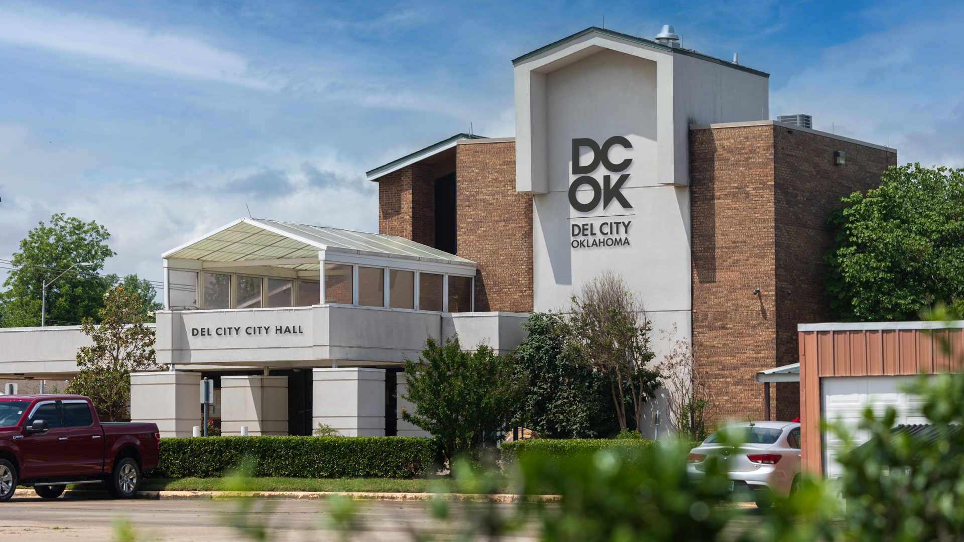 The Del City logo mocked up as elements on the Del City City Hall building.