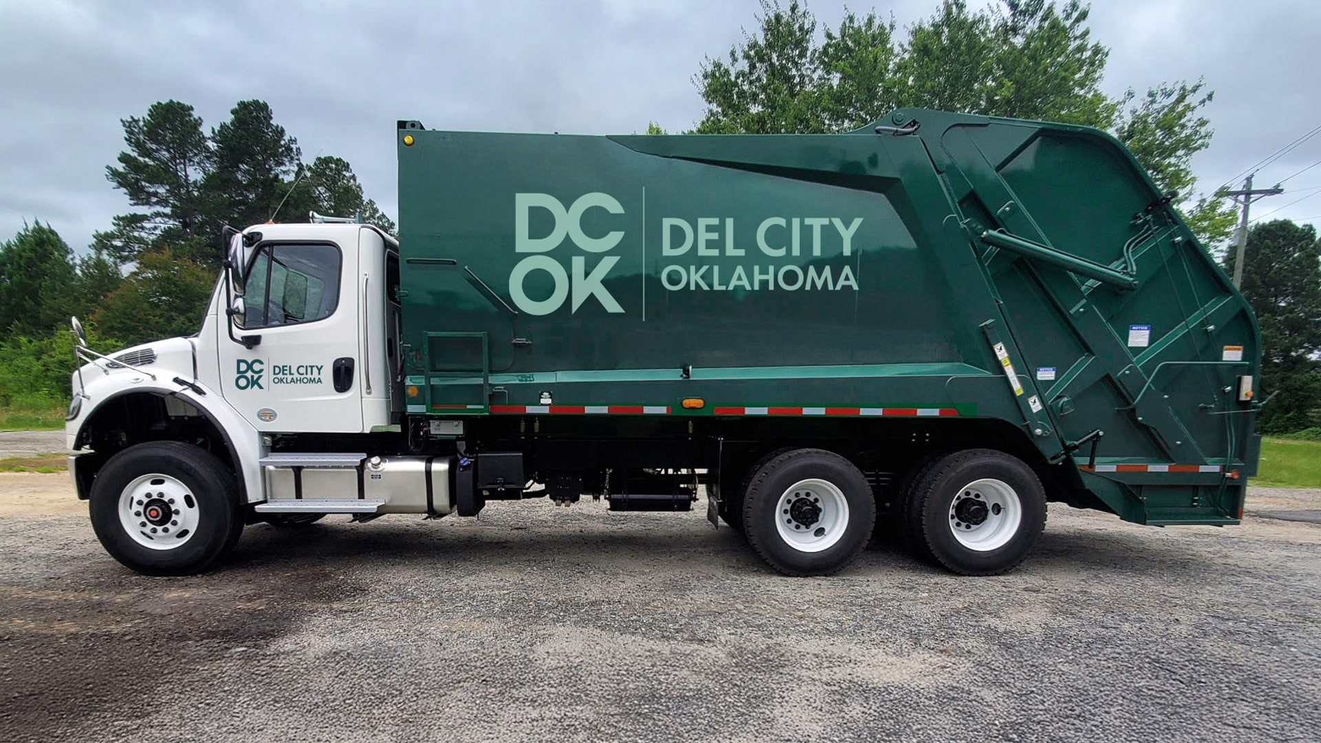 The Del City logo mocked up on a municipal services garbage collection truck.
