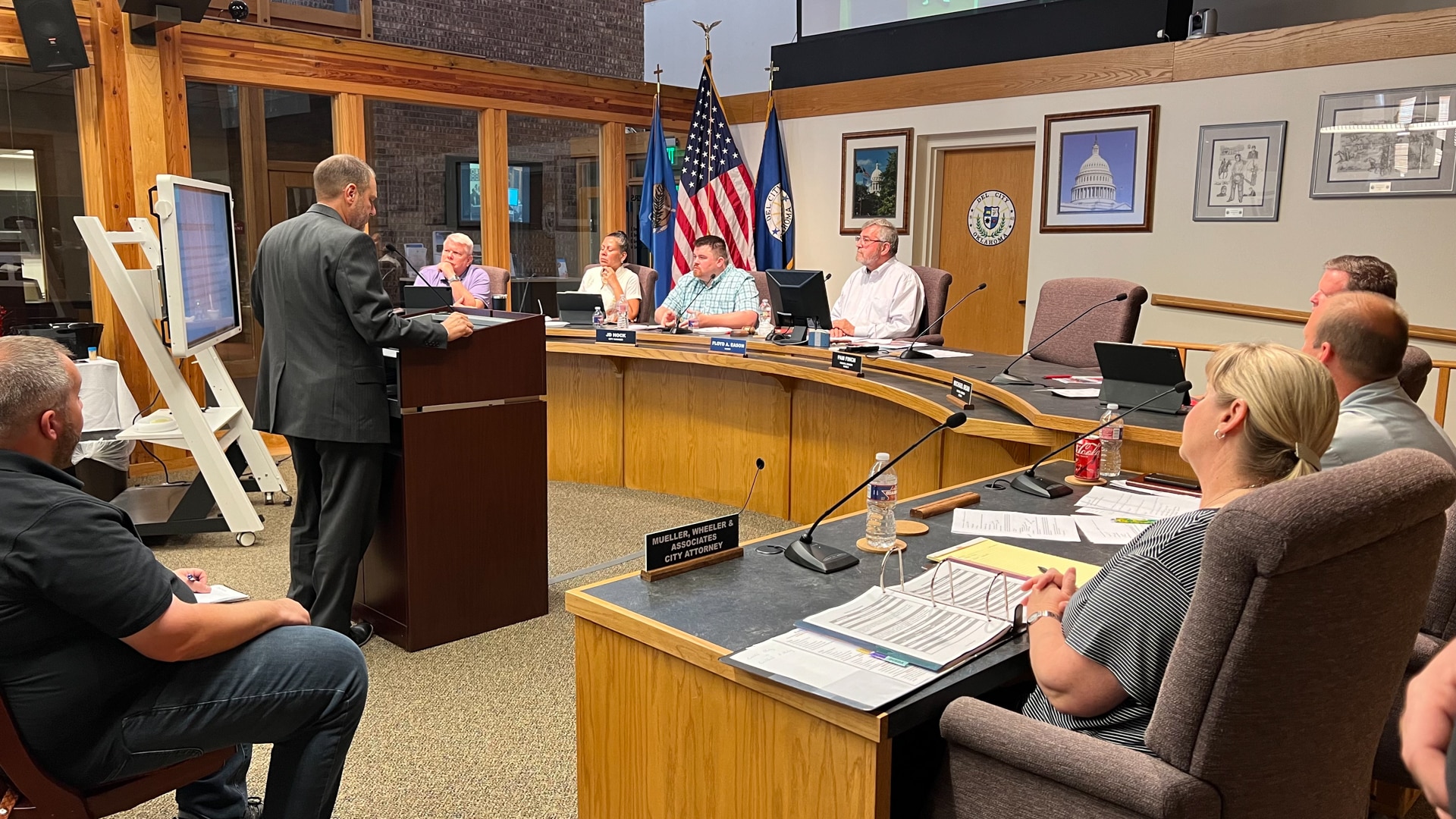 An executive vice president of Koch Comm receives approval of the Del City brand at a city council meeting.