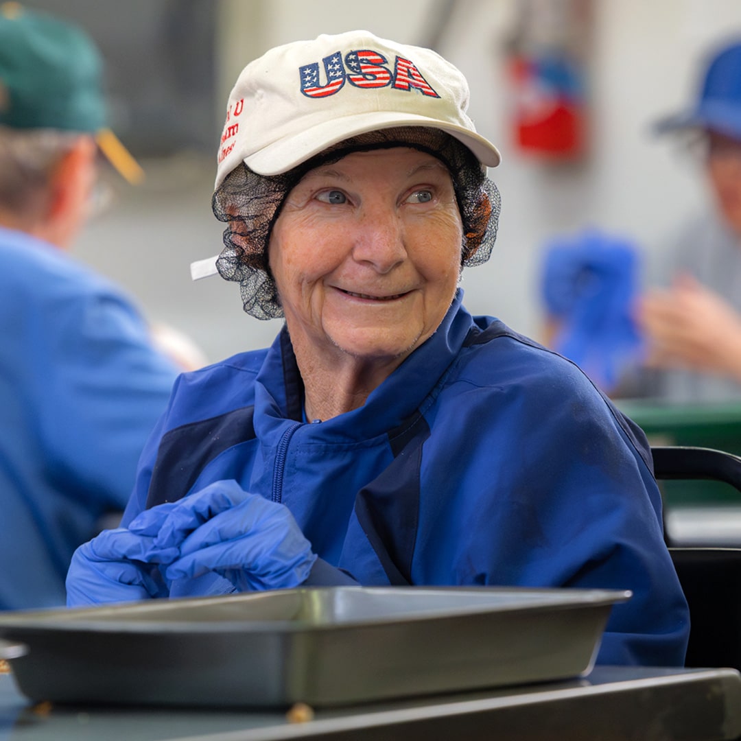 A CARC resident shelling pecans by hand.