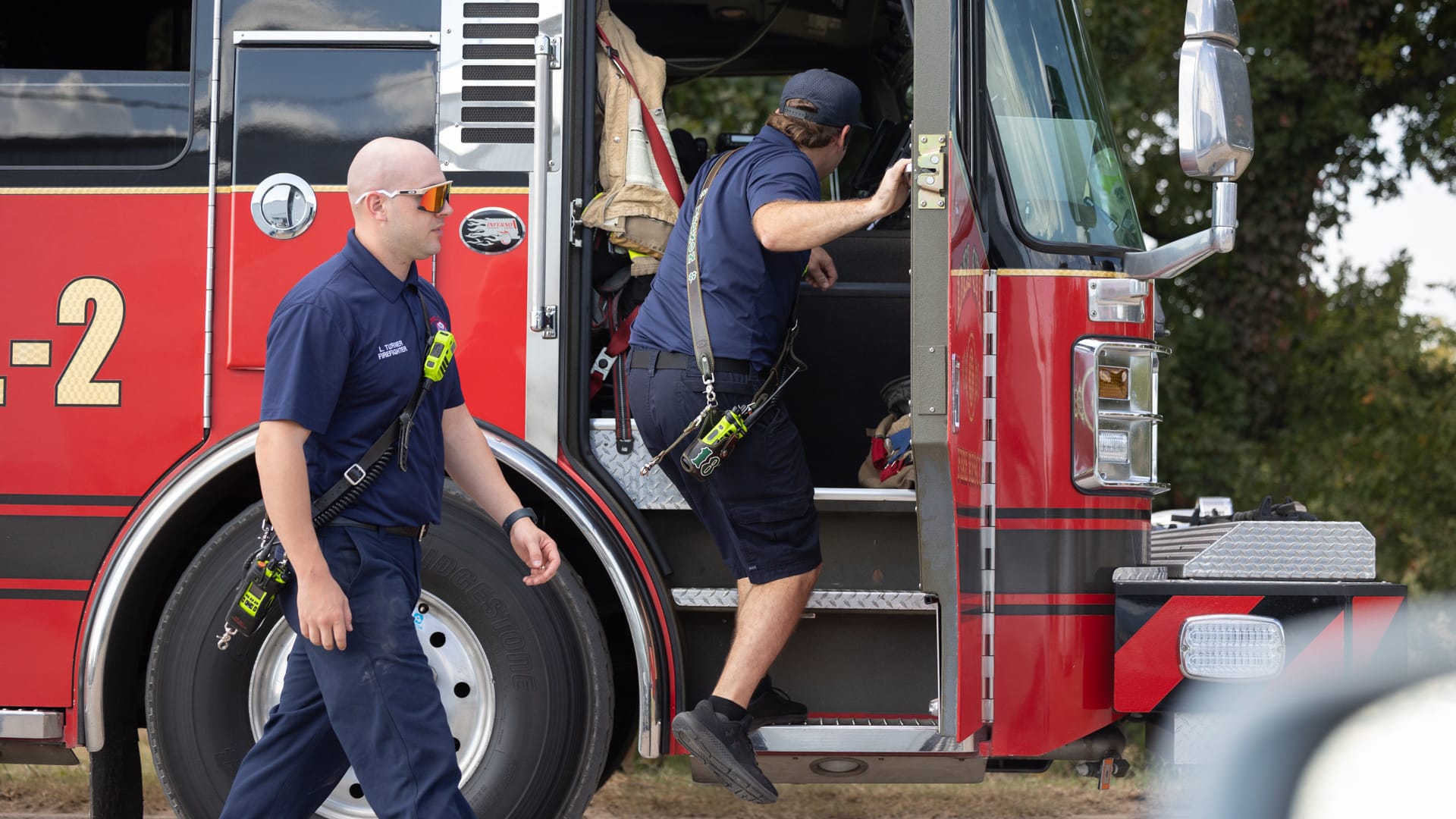 The Del City Fire Department jumps into action as they enter a firetruck.