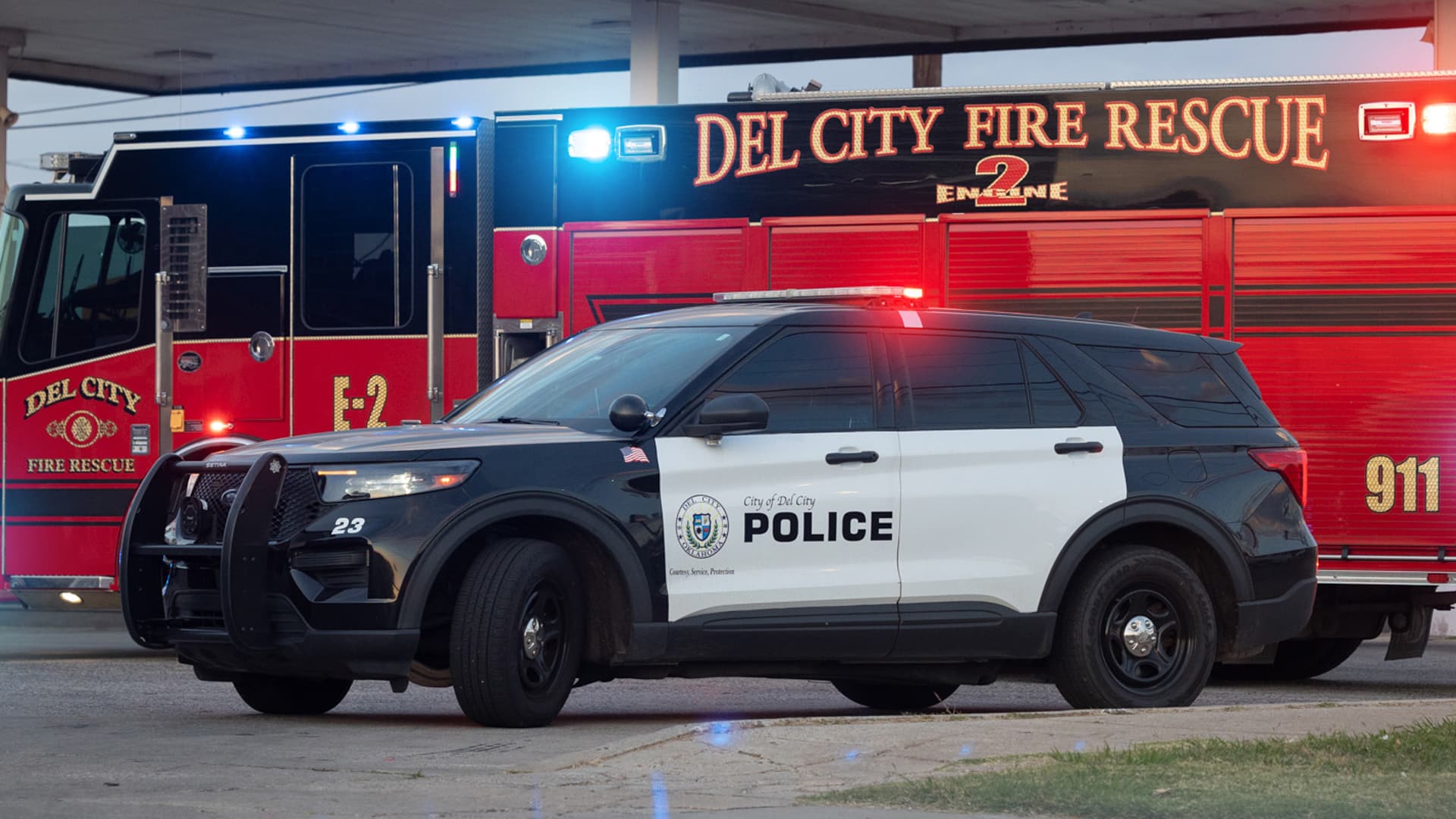A City of Del City police cruiser parked in front of a Del City Fire Rescue engine.