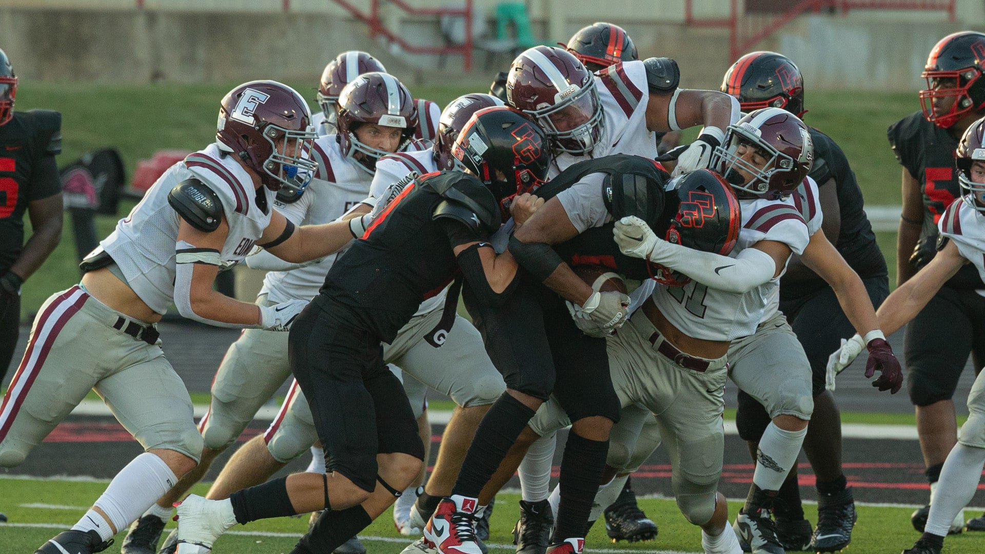 Football players clash during a game at Del City High School.
