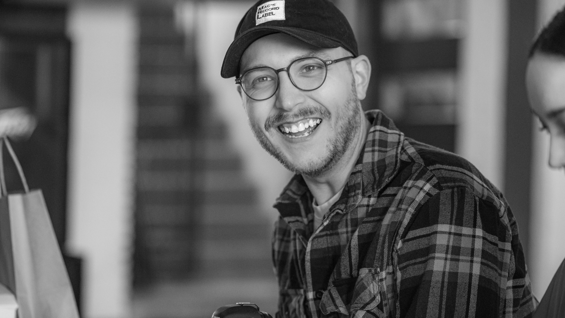 A Koch Comm graphic designer smiling and engaging in a company happy hour.