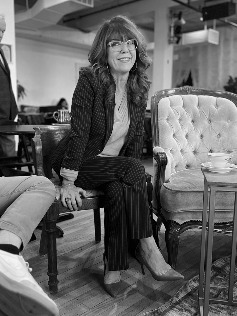 Koch Comm principal, Kym Koch Thompson, smiling at a staff happy hour.