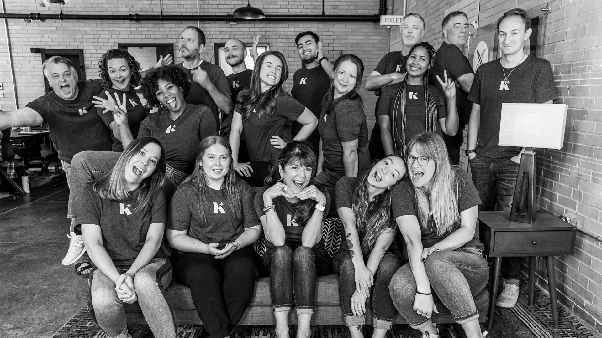 The Koch Comm team smiling for a silly group photo.
